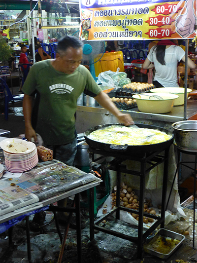 This guy made some sort of egg dish all night on this giant frying pan.