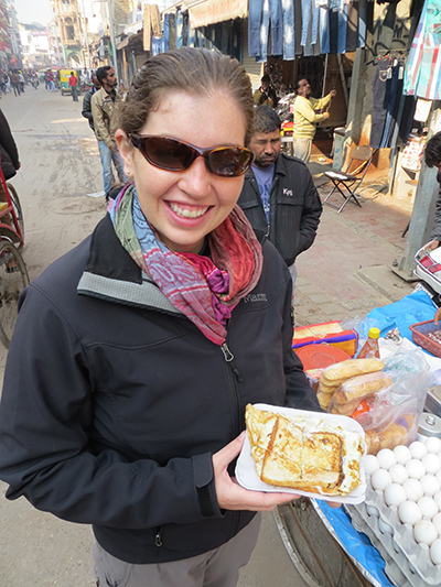 Happy customer with her bread omelette in hand. 