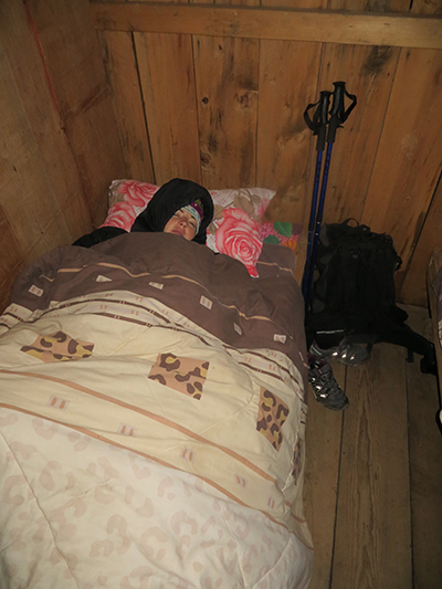 Sarah the morning of day three. We dropped on of our sleeping bags at a previous guesthouse. It was her turn to sleep with the blankets. 