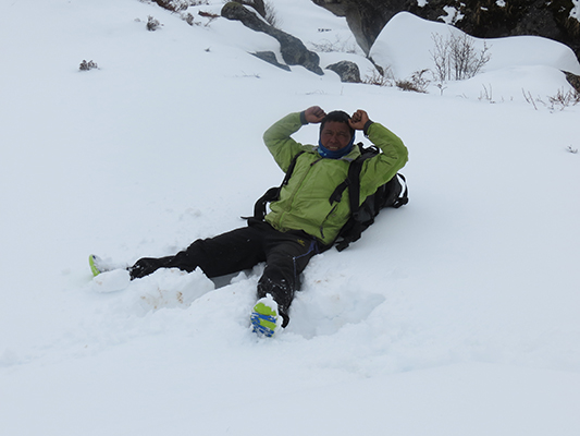 Our friendly volunteer guide/porter playing in the snow. 
