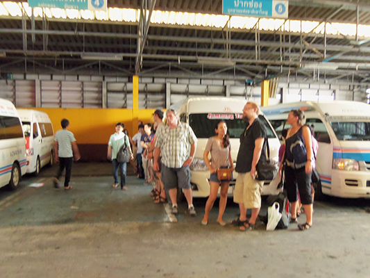 Holding our ground while waiting for the minibus. It was even hotter inside of the station, with the added benefit of car fumes.