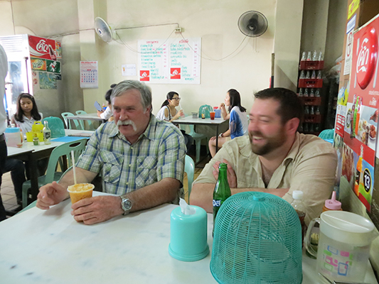 Phil and Jonathan waiting for their first meal in Thailand.