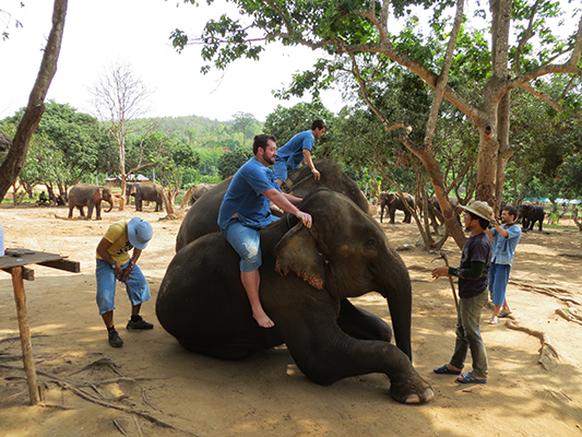 Jonathan mounting the elephant.